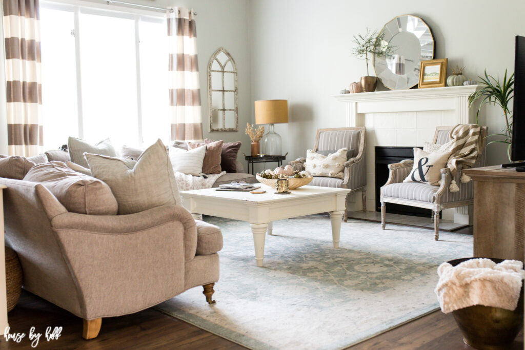 Neutral living room with fall decor and gold accents