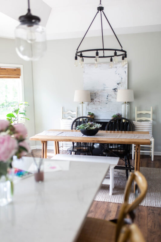 Dining area with black industrial light fixture and modern farmhouse table