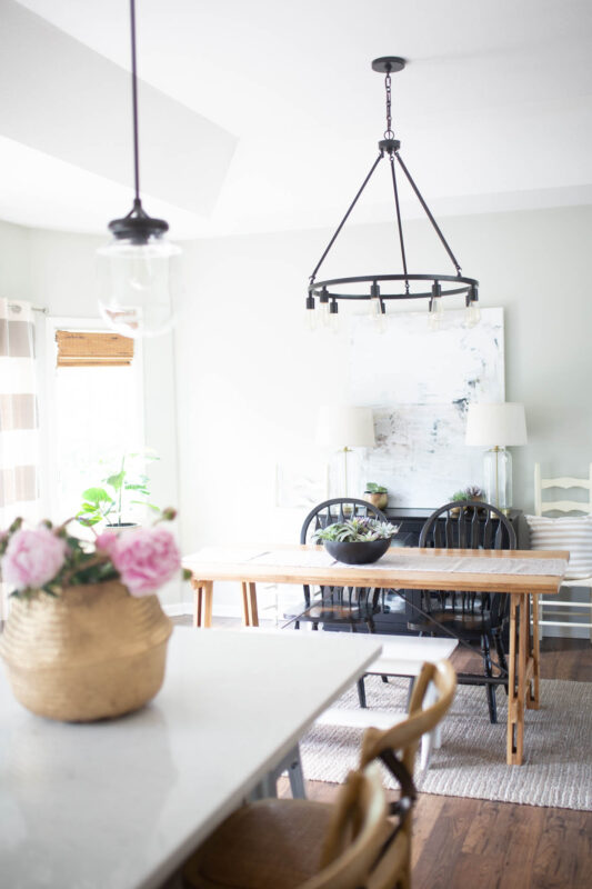 Dining area with black industrial light fixture and modern farmhouse table