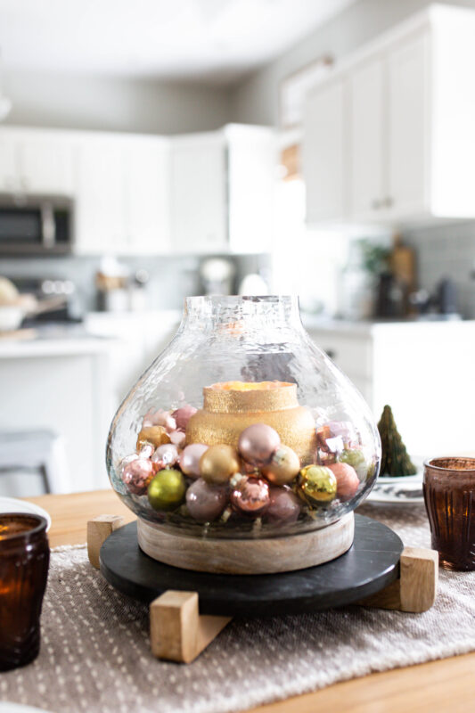 Ornament Centerpiece in Hurricane Vase on Black Pedestal 